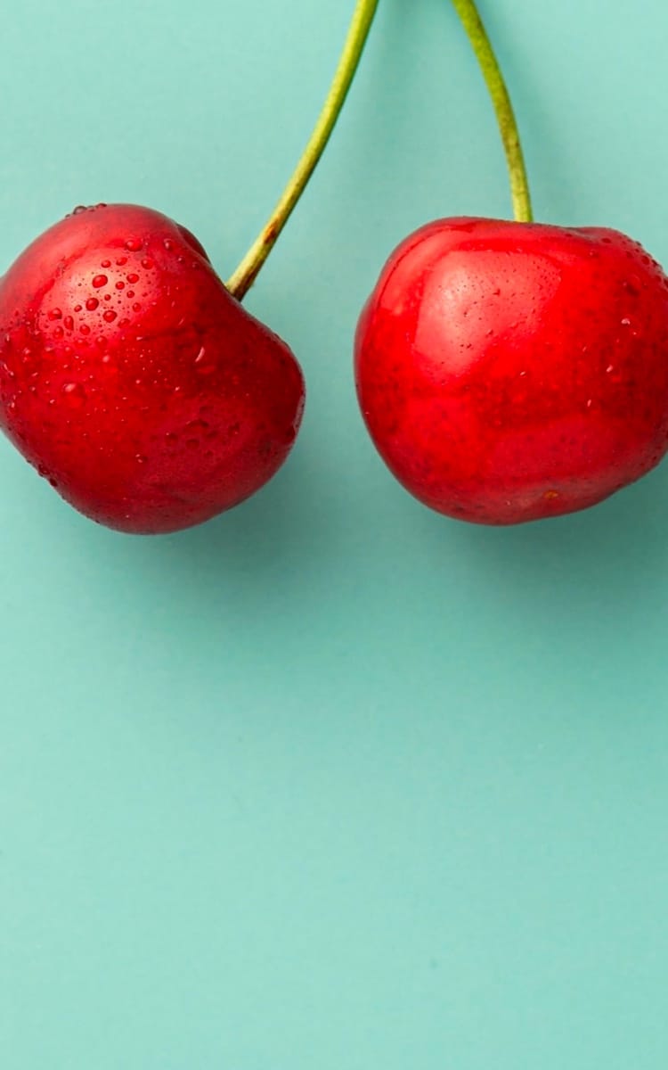 cherries with a green background